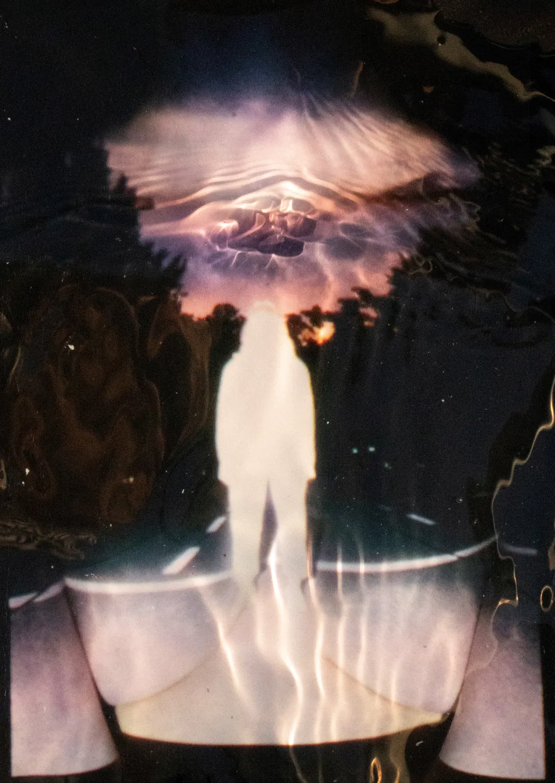 Figure dissolving in refracted light — portfolio cover